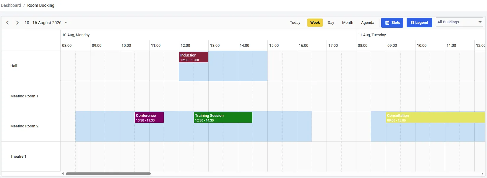 The Room Booking calendar in week view. Rows down the left read Hall, Meeting Room 1, Meeting Room 2 and Theatre 1. Coloured blocks show bookings named Induction, Conference, Training Session and Consultation. Pale blue bands mark bookable time. The toolbar carries Today, Week, Day, Month and Agenda buttons, a Slots button, a Legend button and an All Buildings filter.